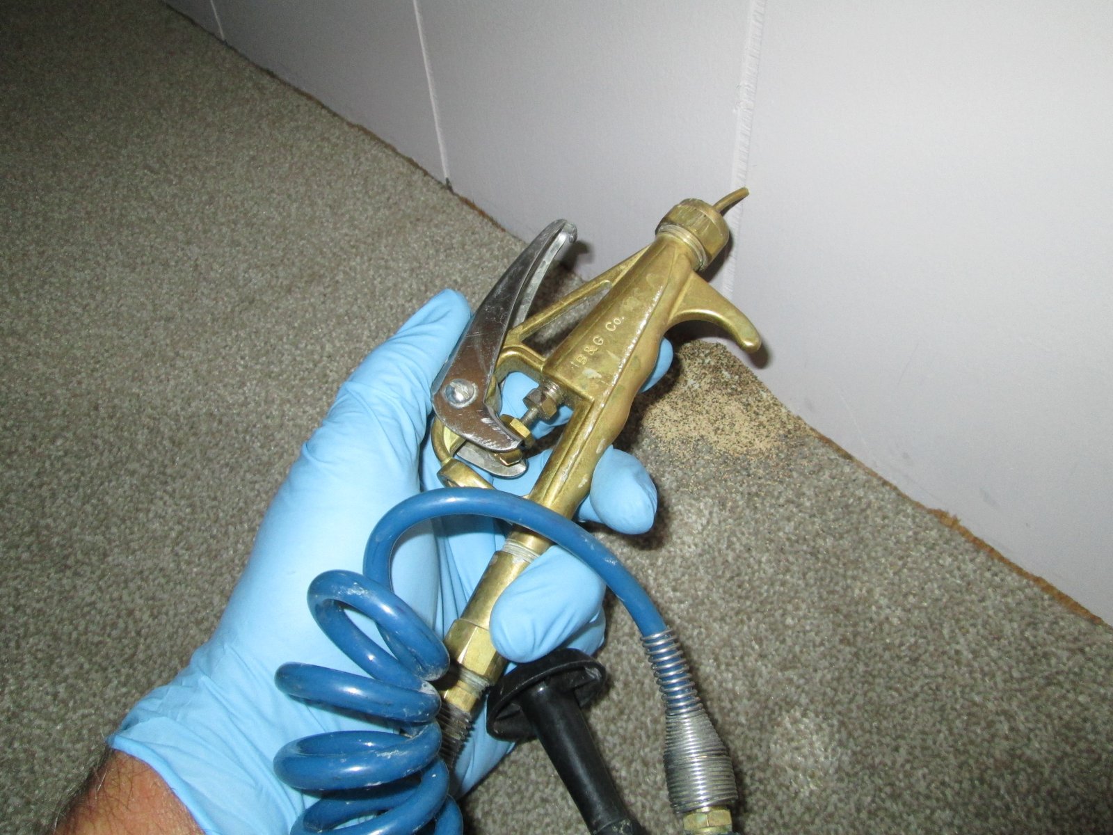 Tiger Termite Control technician applying a localized termite treatment to wood